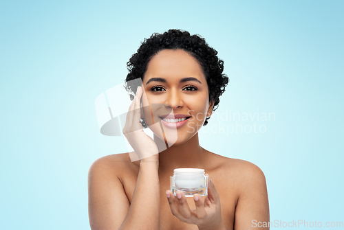 Image of young african american woman with moisturizer