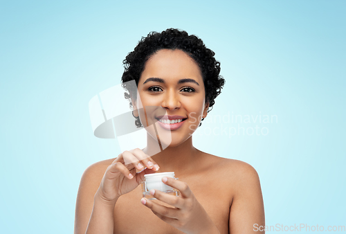 Image of young african american woman with moisturizer