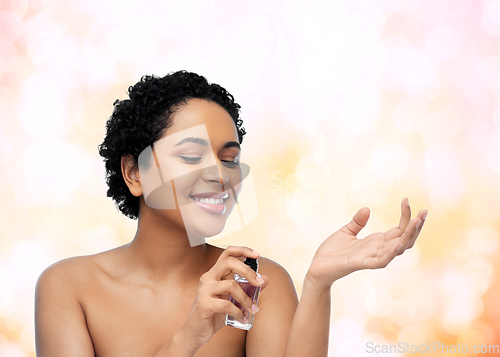 Image of young african american woman with perfume