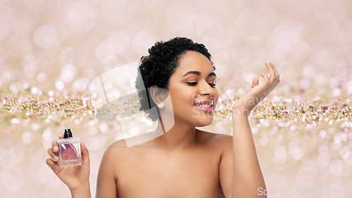 Image of young african american woman with perfume