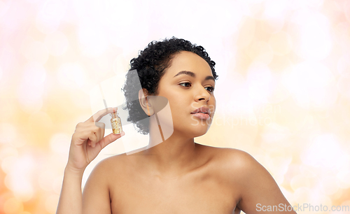 Image of african american woman with gold mask in bottle