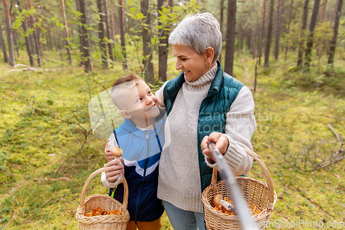 Image of grandmother and grandson with baskets take selfie