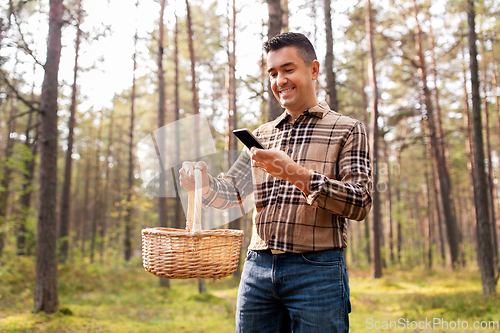 Image of man using smartphone to identify mushroom