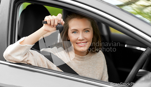 Image of woman or female driver with car key in city