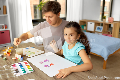 Image of happy father with little daughter drawing at home