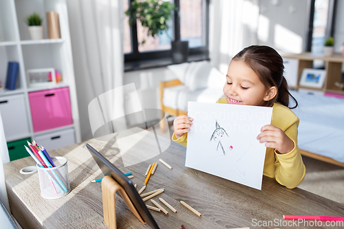 Image of girl drawing and having video call on tablet pc