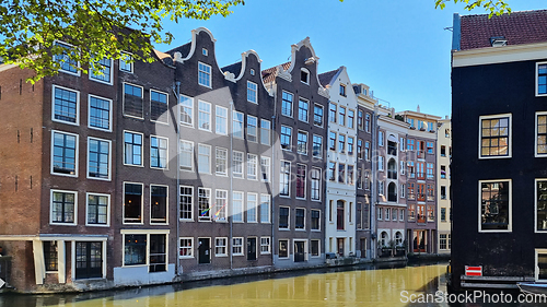 Image of Channel in Amsterdam Netherlands. Houses river Amstel landmark. Old European city summer landscape