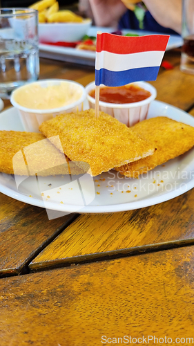 Image of Roasted cheese sticks on a plate with Netherlands flag