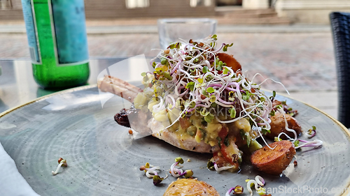 Image of Grilled beef steaks and germinated sprouts on a plate