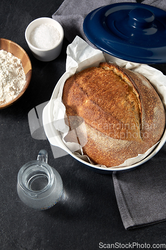 Image of bread, wheat flour, salt and water in glass jug