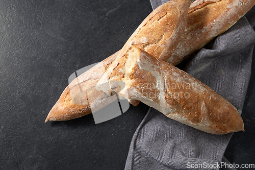 Image of close up of baguette bread on kitchen towel