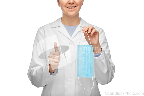 Image of female doctor with medical mask showing thumbs up