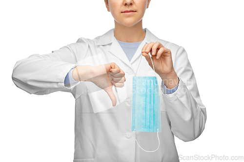 Image of female doctor with mask showing thumbs down