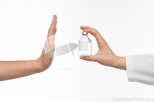 Image of hand with medicine and showing stop gesture