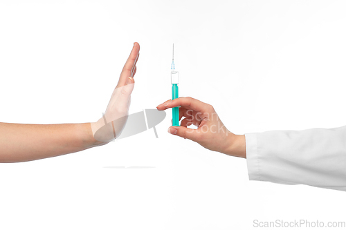 Image of hand with syringe and showing stop gesture