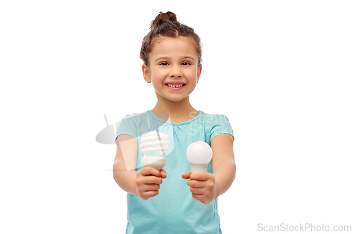 Image of smiling girl comparing different light bulbs