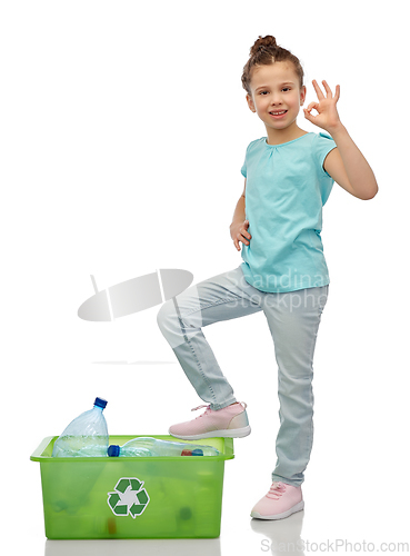 Image of smiling girl sorting plastic waste showing ok sign