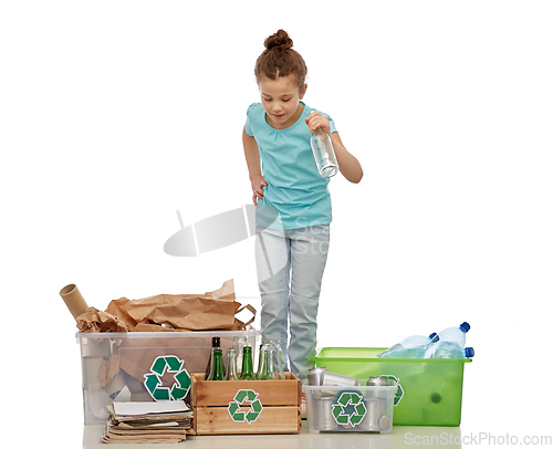 Image of happy girl sorting paper, metal and plastic waste