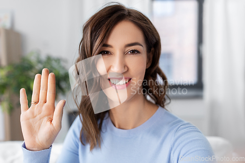 Image of happy woman taking selfie at home