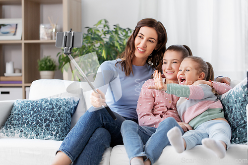 Image of happy family taking selfie by smartphone at home