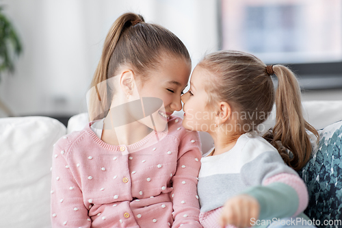 Image of two happy smiling little girls or sisters at home