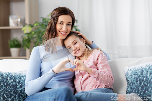 Image of happy smiling mother with daughter at home