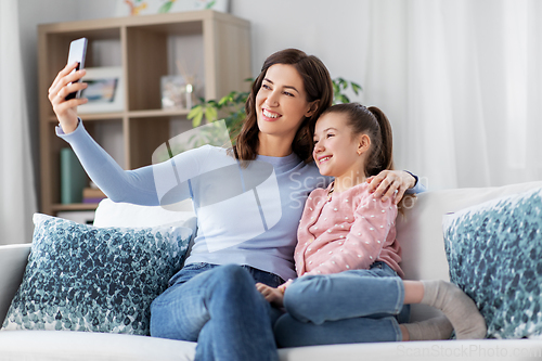 Image of happy family taking selfie by smartphone at home
