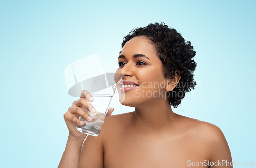 Image of young african american woman with glass of water