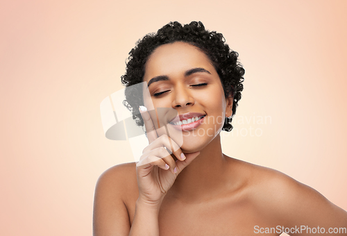 Image of young african american woman with moisturizer