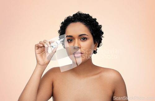 Image of young african american woman with eye drops