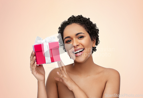 Image of portrait of young african american woman with gift