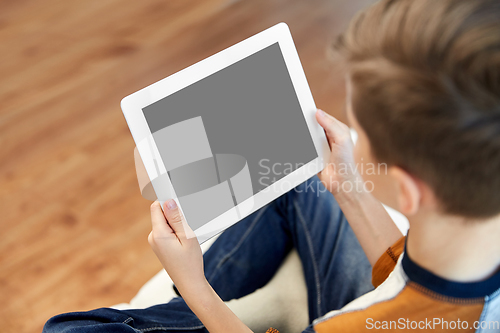 Image of close up of boy with tablet pc computer at home