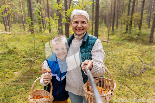 Image of grandmother and grandson with baskets take selfie