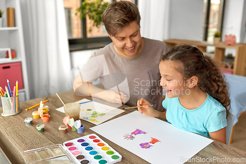 Image of happy father with little daughter drawing at home