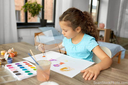 Image of little girl with colors drawing picture at home