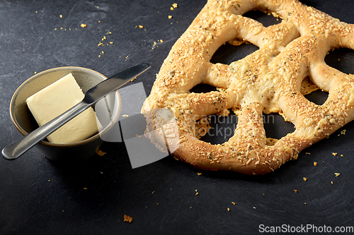Image of close up of cheese bread, butter and table knife