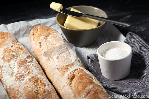 Image of close up of bread, butter and knife on towel