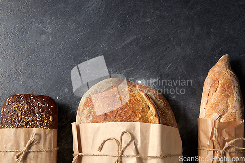 Image of close up of bread in paper bags on table