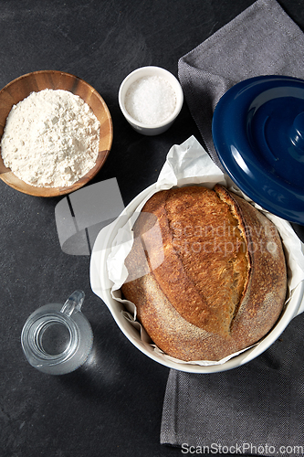 Image of bread, wheat flour, salt and water in glass jug