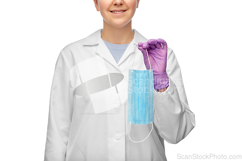 Image of smiling female doctor holding medical mask