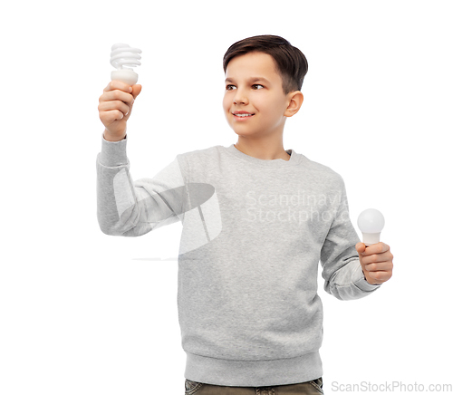 Image of smiling boy comparing different light bulbs