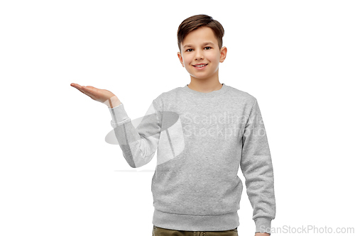 Image of happy boy holding something imaginary on hand
