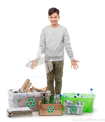 Image of smiling boy sorting paper, metal and plastic waste