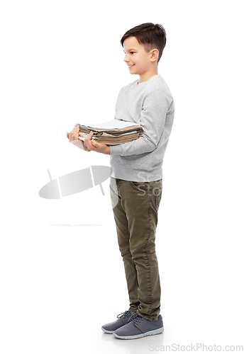 Image of smiling boy with magazines sorting paper waste