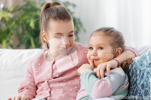 Image of two happy smiling little girls or sisters at home