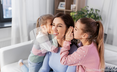 Image of happy mother and daughters gossiping at home