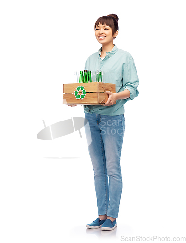 Image of smiling young asian woman sorting glass waste