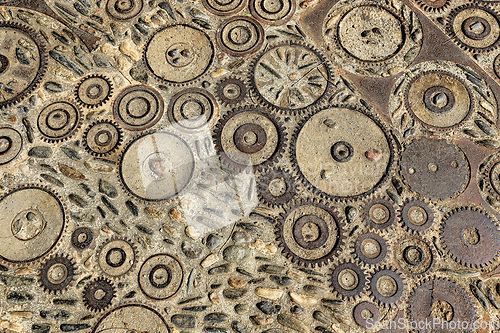 Image of Floor with pattern from pebbles and rusty metal details