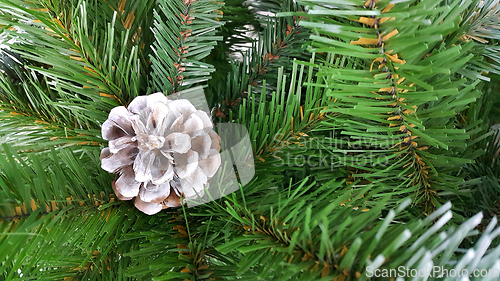 Image of Bright green branches of an artificial Christmas tree with a con