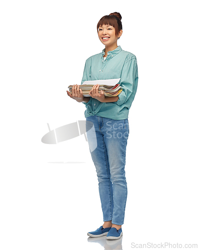 Image of smiling young asian woman sorting paper waste